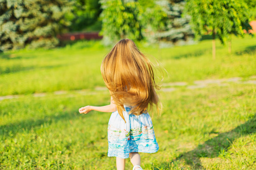 Girl running in the meadow