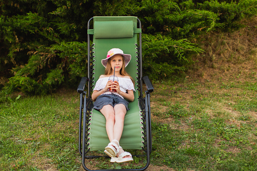 Girl resting on lounge chair