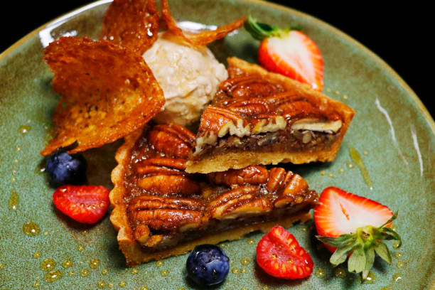 istock pecan nut tart with vanilla ice cream and fresh assorted berries 1499854328