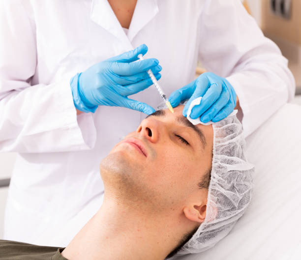 istock Man getting face injections at aesthetic clinic 1499855585