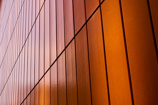 An orange tiled wall on a city car park in manchester