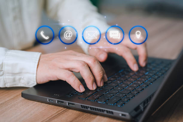 istock Customer using a laptop with virtual screen for apps the call phone, email, address, chat message and map icon. Customer service support hotline contact us people connection technology concept. 1499859401