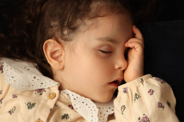 istock Little girl sleeping in her bed 1499859938