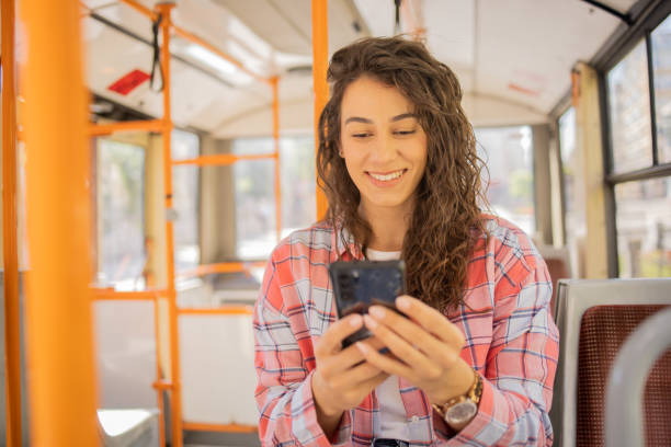 istock Happy young woman riding public transportation 1499863097