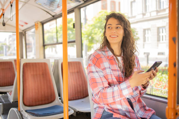 istock Happy young woman riding public transportation 1499863099