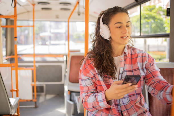istock Happy young woman riding public transportation 1499863100