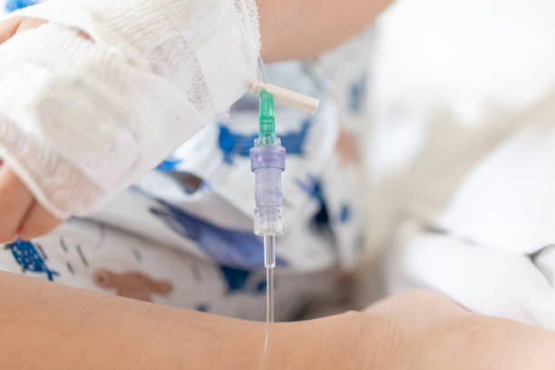 istock Close up child hand with saline IV solution in hospital 1499868290