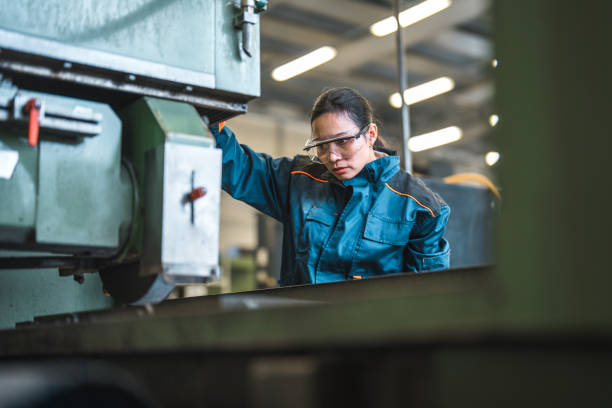 istock Mid Adut Asian Female Factory Worker Operating A Machine 1499869372