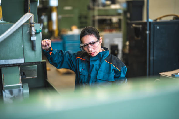 istock Asian Female Blue Collar Worker Operating A Machine 1499869376