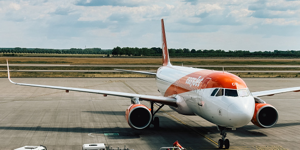 Berlin, Schönefeld, Germany - June 14, 2023: Berlin Brandenburg Airport, aircraft EasyJet before arrivals. Good weather, sky, clouds. Aviation concept photography for traveling photo in Europe.