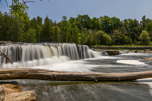 The milky waters of Sauble Falls at the south end of the Bruce Peninsula cascade over the rocks into the river.