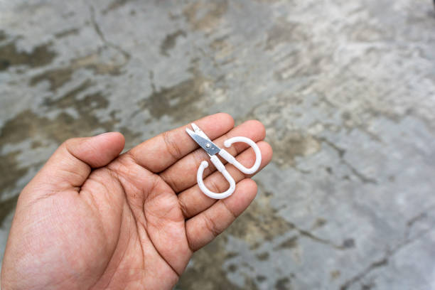 istock cute little scissors for kids playing. Small scissors on adult hand. 1499884321