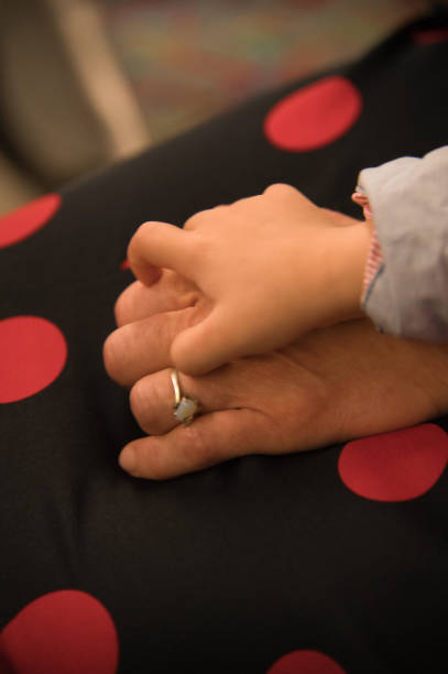istock hands of mother and son 1499887714