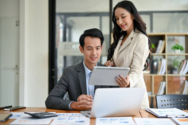 istock A beautiful Asian businesswoman is discussing work, analyzing business financial data 1499894181