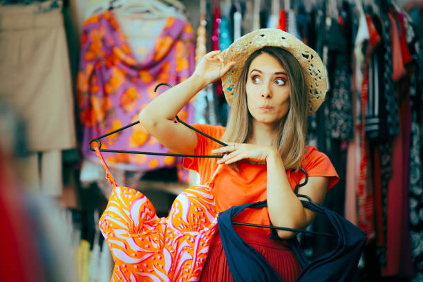 Shopper Girl Choosing Between Two Bathing Suits in a Store