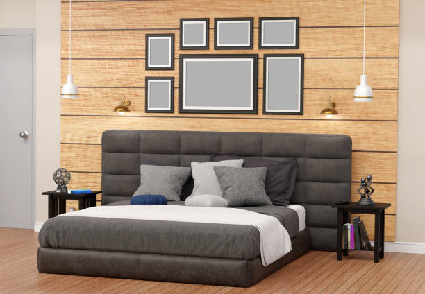 multiple dark photo frames in bedroom, lamp, nightstand, beautiful bed, modern wall wooden decor , metal props and mysterious books, cushions