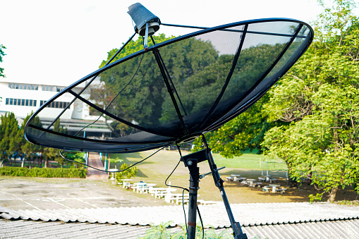 The picture shows a black satellite dish receiving signals in the C Band system in the frequency range 3.4 - 4.2 GHz, located on the roof of the house.