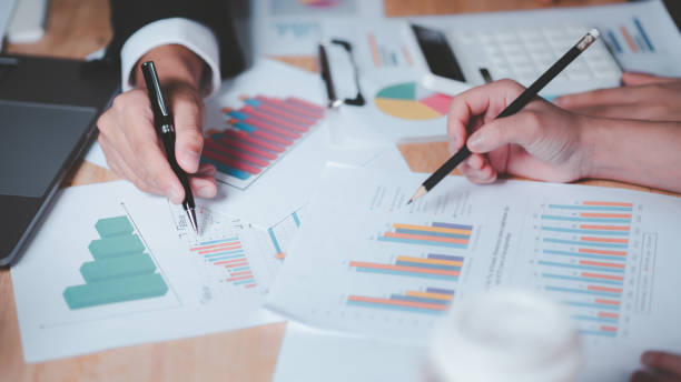 istock statistical analyst reading graph report and business statistics charts ,Analysis and improvement of corporate strategy ,manage financial and marketing documents , Statistics and Data Concepts 1499899241