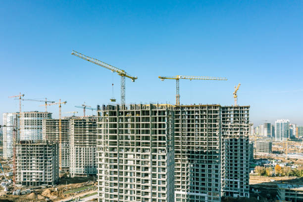 istock construction site with cranes and apartment buildings under construction against blue sky. housing construction concept. aerial photo. 1499900790