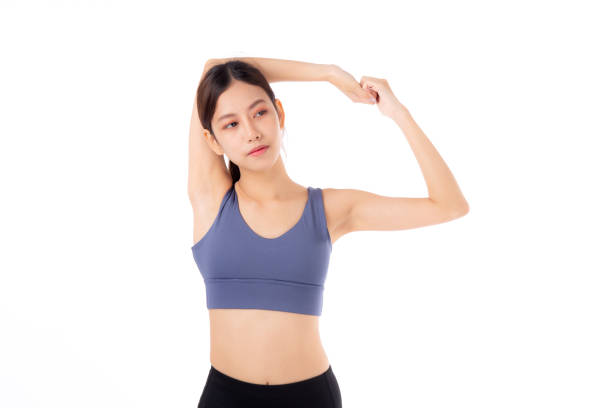 Portrait beautiful young asian woman stretching hands or arms for exercise yoga and relax isolated on white background, female workout training for muscle strong, sport and health care concept. stock photo