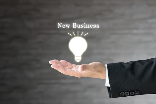 Business man's hand and light bulb pictogram with 