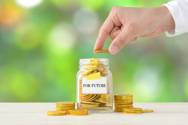 istock Human's hand putting money into bottle with 