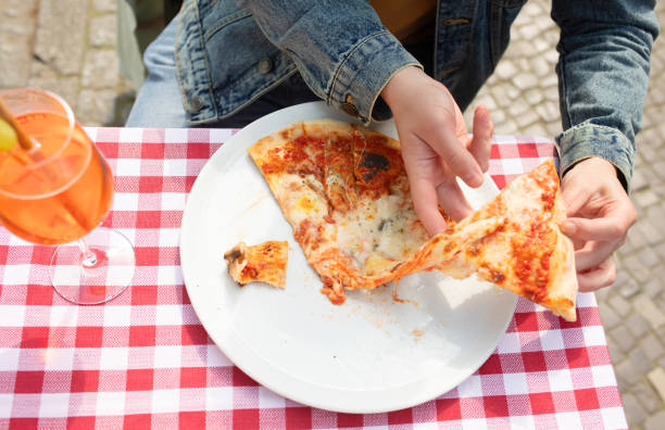 istock Hand grabbing slice of cheesy pizza. 1499912090