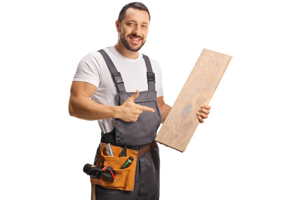 istock Carpenter holding a wooden floor beam and pointing 1499918979