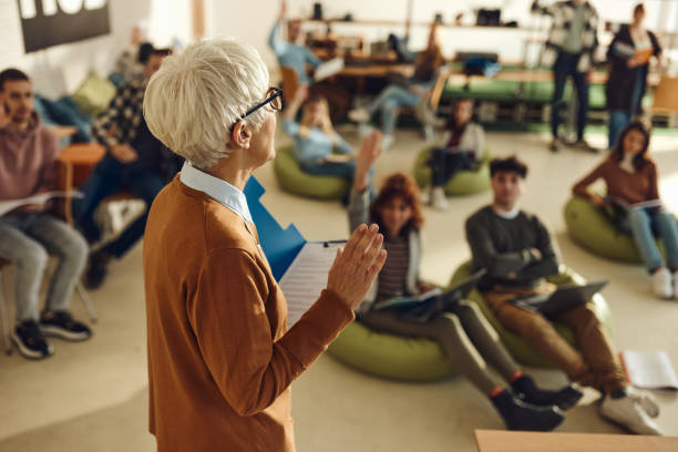 istock Mature female professor giving a lecture in a modern classroom. 1499920766