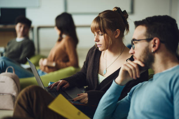 istock Couple of students e-learning at casual classroom. 1499920852
