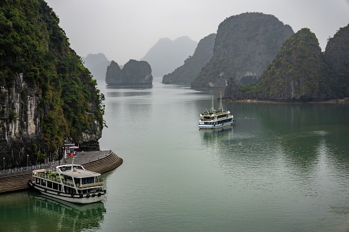An aerial view of cruise ships navigating through Halong Bay in Vietnam, Southeast Asia