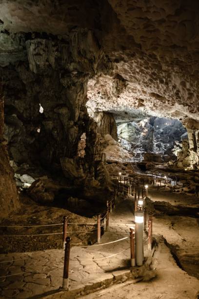 istock a cave with a pathway leading to the cave entrance and a bridge going through it 1499920951