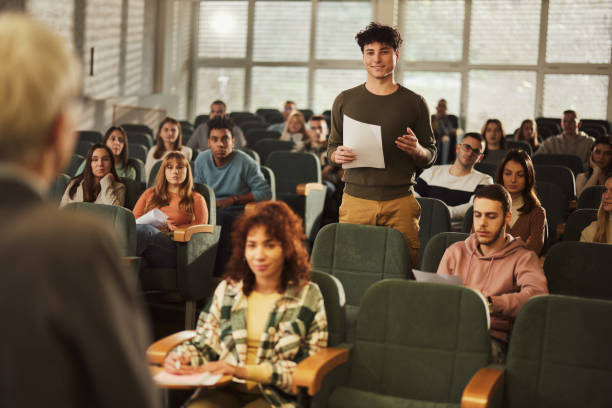 istock Happy male student talking to a professor on a class in a lecture hall. 1499921573