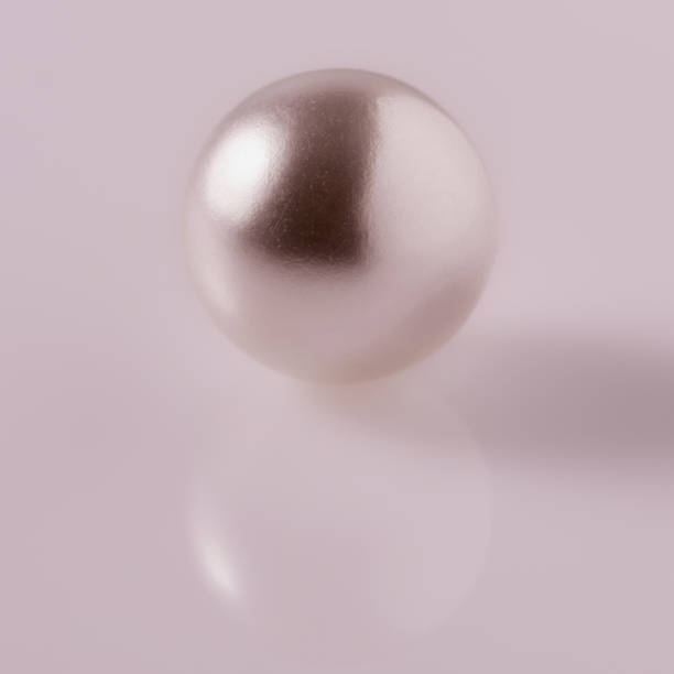 istock One big beautiful pearl on a light glossy background 1499922164