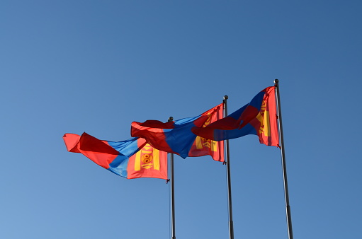 Norwegian flag waving in the wind with blue sky