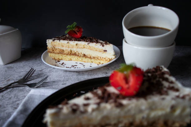 istock Coffee and cake with chocolate and strawberries on a black plate. 1499925113