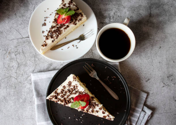 istock Coffee and cake with chocolate and strawberries on a black plate. 1499925652