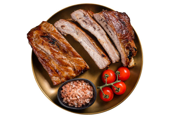 istock Chopped BBQ pork ribs  on a plate with herbs. Isolated on white background. 1499926226