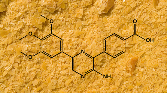 Organic carnauba wax flake with molecular structure. Chemical ingredient used in cosmetic industry.