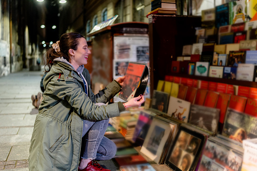 Young Woman Searches for Unique Books and Records on the Streets