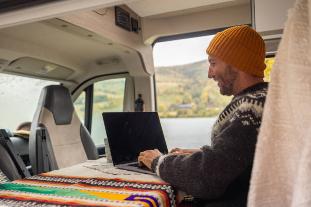 istock Man working remotely, van life concept 1499938919