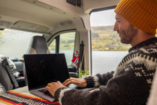 istock Man working remotely, van life concept 1499938922