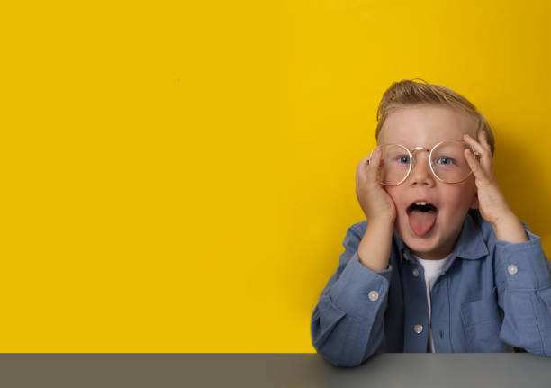 istock A fair-haired boy in glasses grimaces on a yellow background copy space 1499941823