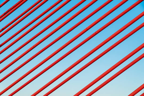 Red cable of a cable car bridge. Red wire background. Symmetry concept, construction.