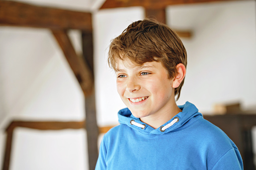 Portrait of preteen school kid boy. Beautiful happy child looking at the camera. Schoolboy smiling. Education concept
