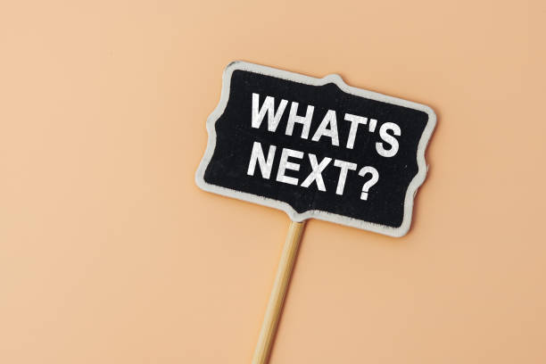 istock What's Next? - text on a small chalkboard on a beige background. Top view. Strategy and vision for work 1499943803