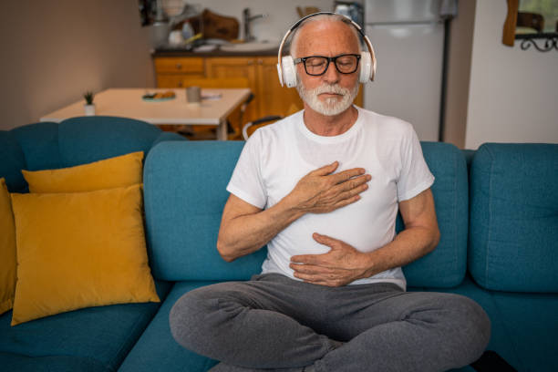 istock A mature senior man sits on a bed and practices guided meditation in his home 1499944020