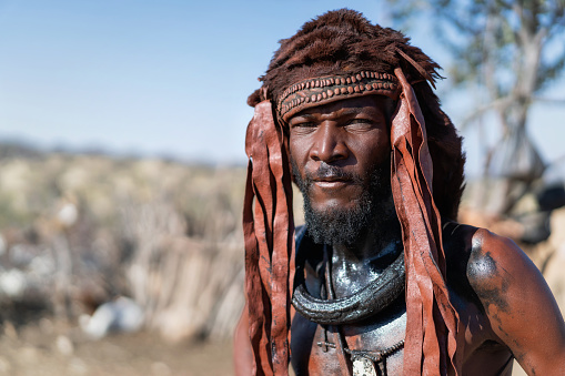 Kamanjab, Namibia - June 16, 2023: Himba man dressed in traditional style at his village near Kamanjab in Namibia, Africa.