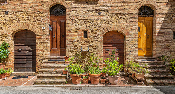 Door and window features of apartments along the streets of Pienza in Tuscany Italy at dusk