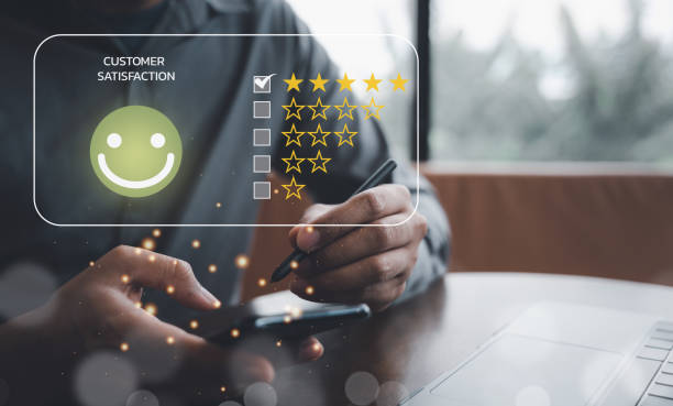 istock Man using smartphone and laptop computer to rate and evaluate services 1499947774